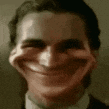 a close up of a man 's face with a big smile on his face .