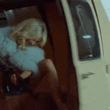 a woman in a fur coat is sitting in the back seat of a car .