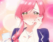 a girl with pink hair and green eyes is holding a phone