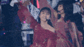 a woman in a red dress is holding a white flag that says ' nct ' on it