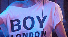 a woman wearing a white shirt that says boy london on it