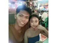 a man and a woman are posing for a photo in a restaurant