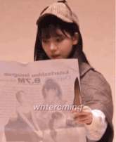 a girl wearing a hat and a jacket has the word wintercming written on her face