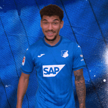 a man wearing a blue shirt with the word sap on the front