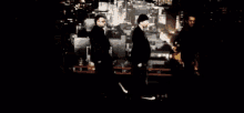 a group of men standing in front of a city skyline