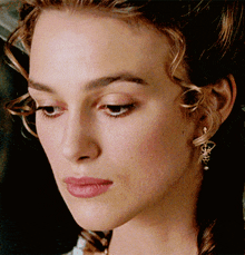 a close up of a woman 's face with her eyes closed