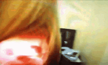 a blurry picture of a person 's face with a red glow in the background
