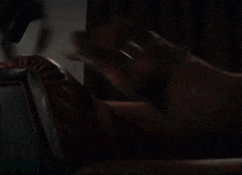 a blurry picture of a person in a dark room with a door in the background .