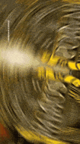 a blurred image of a yellow object with the letters nsb on the bottom right corner