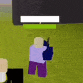 a person is holding a gun in a video game while standing in the grass .