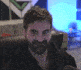 a man with a beard is making a funny face in a room .