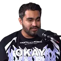 a man with a beard wearing a shirt that says okay on it