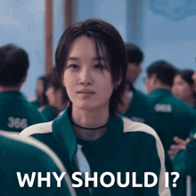 a woman in a green jacket with the words why should i on it