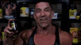 a man is holding a bottle of pro tein in front of a shelf