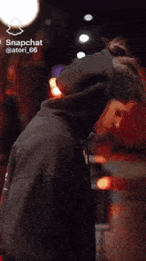 a woman is wearing a black hoodie and snapchat is displayed