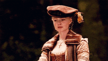 a woman wearing a hat and a necklace is on showtime