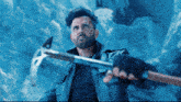 a man in a leather jacket holds a large axe
