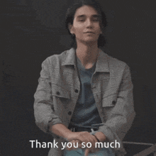 a young man in a plaid jacket is giving a thumbs up and saying thank you so much .