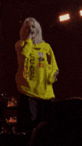 a person in a yellow shirt that says lulu ban on it