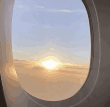 a view of the sun through an airplane window .