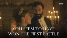 a man in a tuxedo stands next to a woman in a tiara with the words you seem to have won the first battle