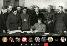 a group of men are gathered around a table with a discord logo in the middle