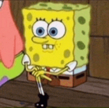 a close up of spongebob squarepants sitting on a wooden floor