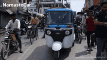 a namaste car is driving down a busy street in india