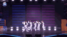 a group of women are dancing on a stage with a sign that says stop move on it