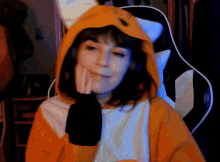 a woman in a fox costume is sitting in a chair with her hand on her face