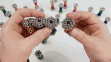 a person is playing with a bunch of magnets