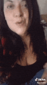 a woman is making a funny face with a tiktok watermark