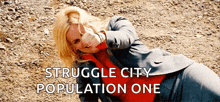 a woman in a suit is laying on the ground with the words struggle city population one below her