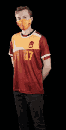 a man wearing a red and yellow jersey with the number 17