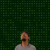a man with glasses stands in front of a green background with the number 3:11