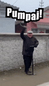 a man with a cane and a sign that says pumpaj on it