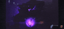 a purple light is shining in a dark room with a zebra print on the wall behind it