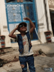 a little boy wearing sunglasses and a hat is standing in front of a sharechat icon