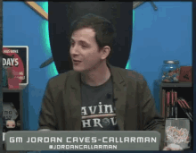 gm jordan caves-callarman is sitting in front of a sign that says has gone days