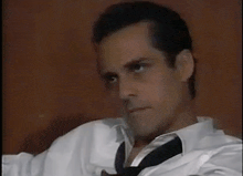 a man wearing a white shirt and black tie