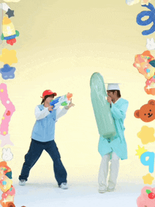 a man in a cap and gown is holding a water gun
