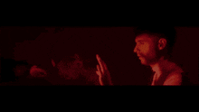 a person 's hand is reaching for a red light