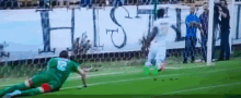 a soccer player in a green uniform with the number 2 on his back