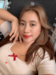 a woman wearing a white shirt with cherries on it is laying down
