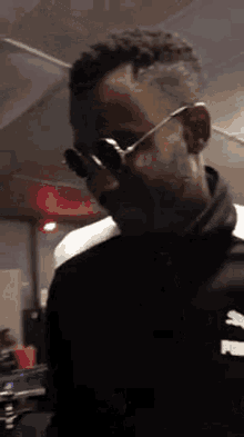 a man is wearing sunglasses and talking on a cell phone .