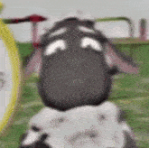 a cartoon sheep with a sad look on its face .