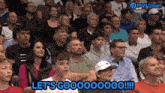 a crowd of people sitting in a stadium with the words let 's go on the bottom