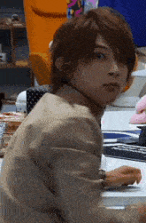 a man in a suit is sitting at a desk with a mouse pad on it .