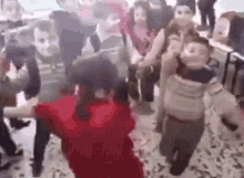 a group of children are dancing in a classroom in a classroom .