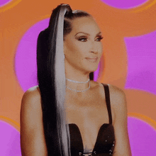 a woman with long black and white hair is wearing a choker and a black top